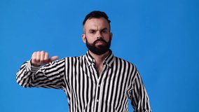 4k slow motion video of one man showing thumb down on blue background.
