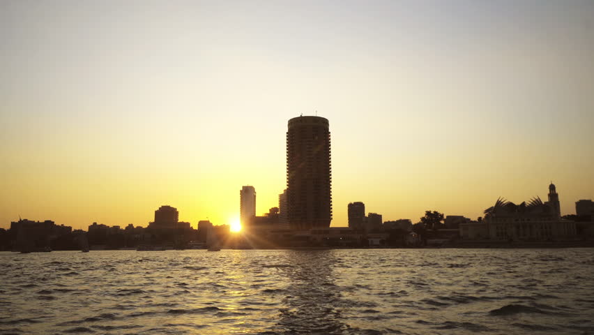 Cairo skyline at sunset, Egypt. View from a sailing boat on the Nile river at sunset, sunrise. Travel and vacation in Egypt