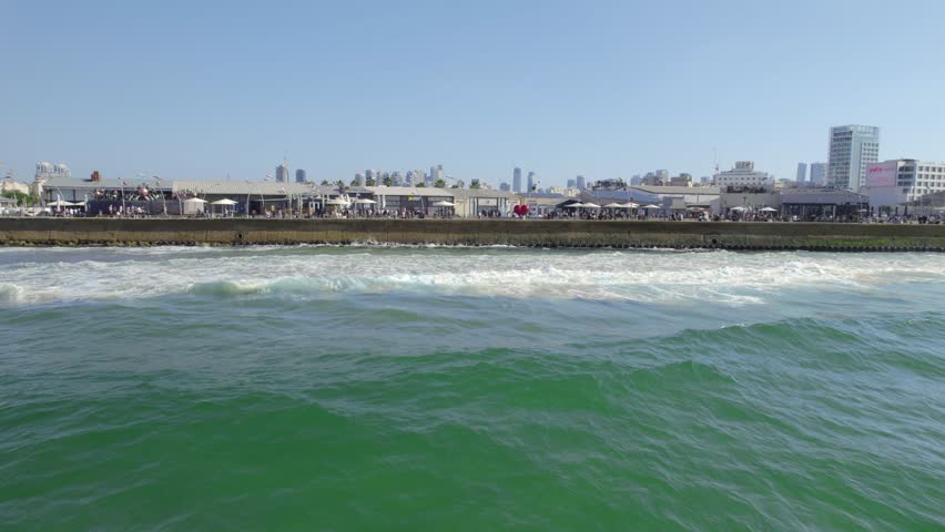 Push in over Tel Aviv Port Promenade and revealing the Beautiful city's skyline #015