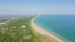 Inscription on video. Venice, Italy. Beaches of Punta Sabbioni. Cavallino-Treporti. Clear sunny weather. Arises from blue water, Aerial View