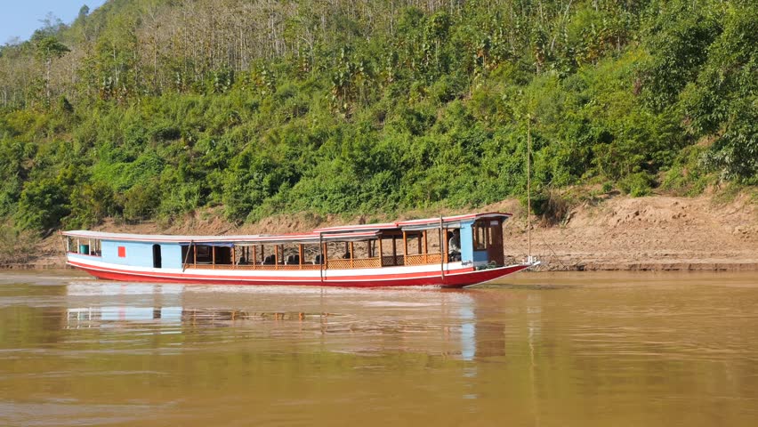 Mekong River Cruise Trip on Slow Wooden Boat from Luang Prabang High Quality 4K Slowmotion Tourism and Travel in South East Asia Concept Footage. Laos. Royalty-Free Stock Footage #1098184059
