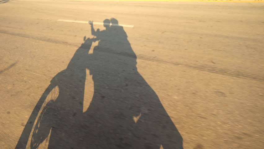 Sunset Light Shade on Asphalt Road of Young Tourist Couple Riding Motorbike in Asia. High Quality 4K Slowmotion Travel Lifestyle Footage. Thailand.