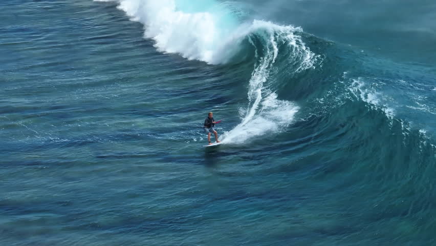 An athlete on a wave board rides the big ocean waves of a living reef in the Indian Ocean. One of the best surf spots on the planet. Sports hobby Royalty-Free Stock Footage #1098184713