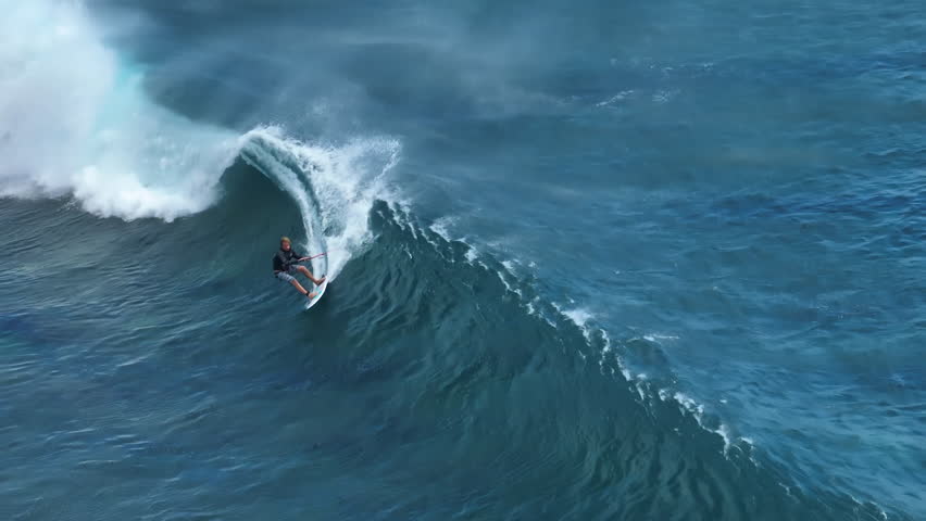An athlete on a wave board rides the big ocean waves of a living reef in the Indian Ocean. One of the best surf spots on the planet. Sports hobby | Shutterstock HD Video #1098184713