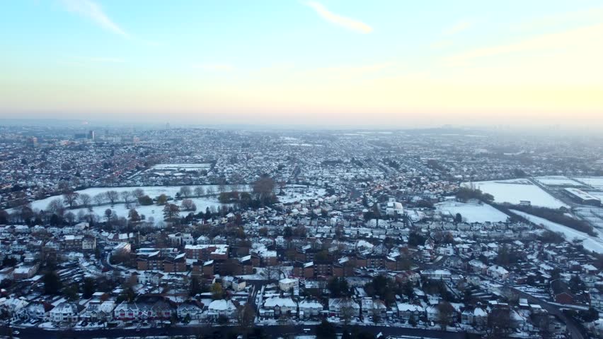 Wide angle establishing aerial shot of town covered in snow, England