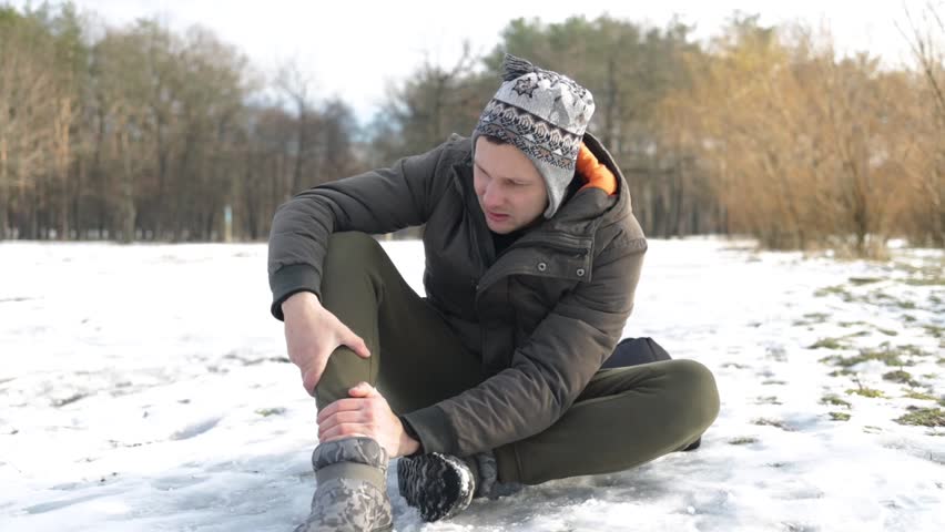 Young modern man slipped and falling to the snow.