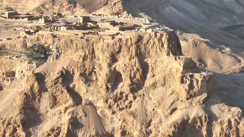 Aerial view of visitors on the summit of Masada national park table top mountain