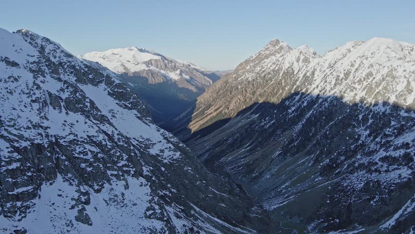 Drone footage of a snowy valley.