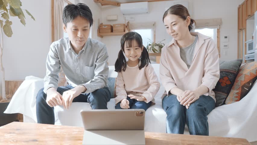 Parents and child looking at the tablet PC screen Royalty-Free Stock Footage #1098198875