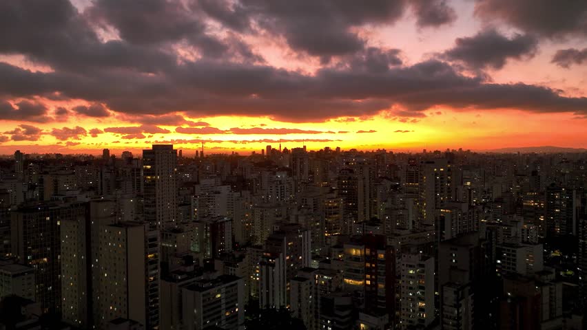 Sunset at Sao Paulo Brazil. Cityscape of sunset sky at city Sao Paulo Brazil. Scenic landscape of colorful sky and illuminated towers offices buildings and skyscrapers. Urban life scenery.