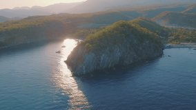 Bay at sunset. Dense forest on the coast. Water transport floats. Light fog. Aerial drone video footage 
