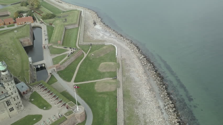 Seashore with a harbour in the background and next to some towers