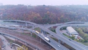 View of the road junction in front of the Darnitsky bridge in Kyiv, Ukraine. Road, highway, cars. Drone video 4K.