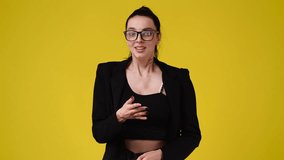 4k slow motion video of girl's facial expression on yellow background.