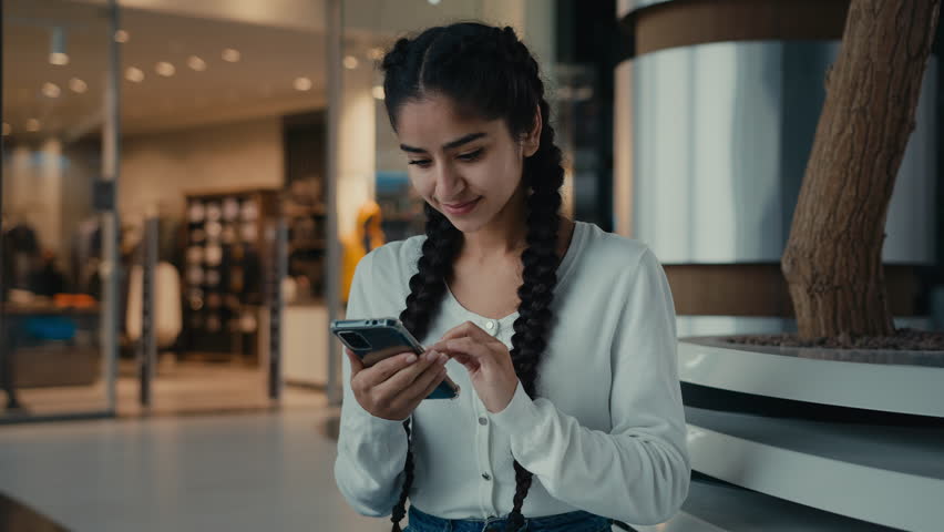 Young hispanic woman ethnic girl businesswoman student excited female user win discounts on mobile phone business achievement success receive good news celebrate victory online profit new smartphone Royalty-Free Stock Footage #1098212305