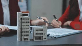 Discussion with a real estate agent, House model with agent and customer discussing for the contract to buy, get insurance or loan real estate or property. - Powered by Shutterstock - Get 15% off with code: PIKWIZARD15