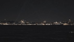 Istanbul skyline in the night. Istanbul 4k video. Galata Tower and Suleymaniye Mosque in the view. Spotlight rays.