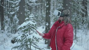 girl in winter forest wearing virtual reality glasses. High quality Full HD video recording. live video