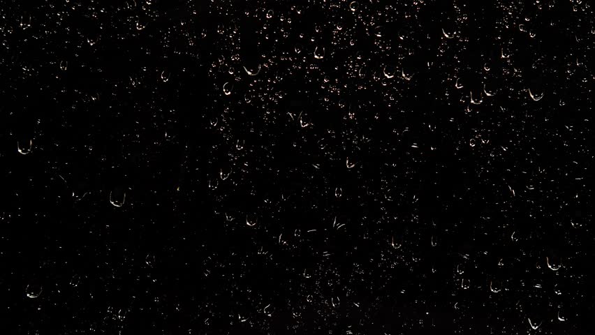 Drops of Night rain water flow down the black glass. The drops are illuminated and sparkle Royalty-Free Stock Footage #1098224005