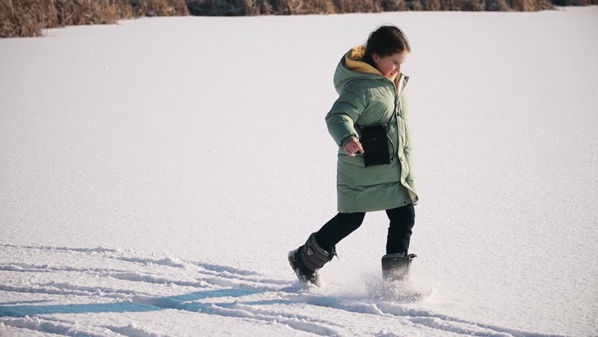 happy girl running on fresh snow