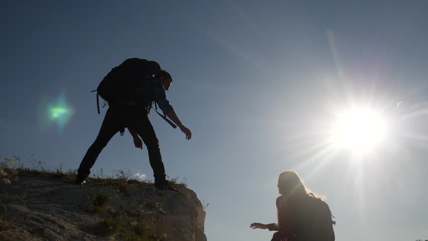 Helping hand. help business travel silhouette concept. group team of up tourists lends helping hand a climb the cliffs mountains. teamwork people climbers climb top to helping hand hardships the path | Shutterstock HD Video #1098230823