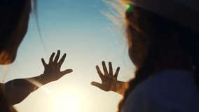 hands in the sun. mom and daughter hands reach out to the sun silhouette sunlight. happy family kid dream concept. mom and sunset daughter dream of god religion concept - Powered by Shutterstock - Get 15% off with code: PIKWIZARD15