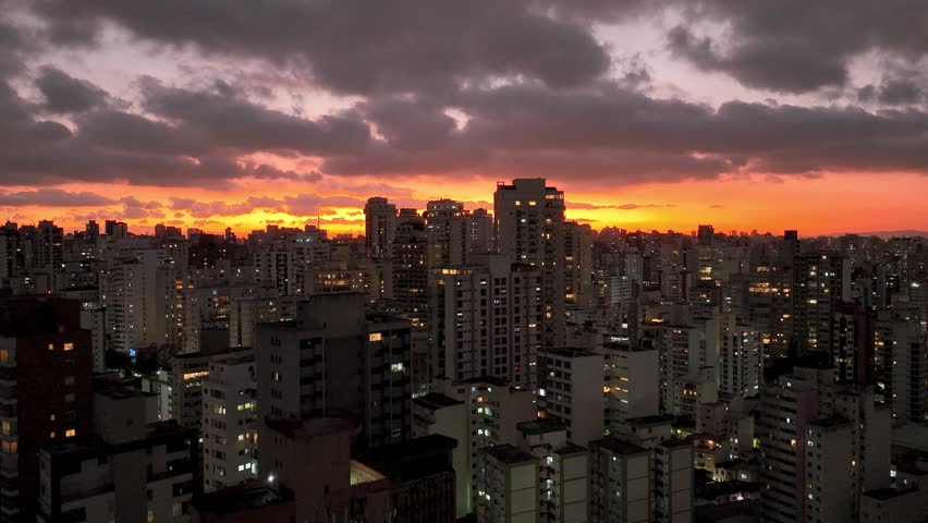 Sunset at Sao Paulo Brazil. Cityscape of sunset sky at city Sao Paulo Brazil. Scenic landscape of colorful sky and illuminated towers offices buildings and skyscrapers. Urban life scenery.