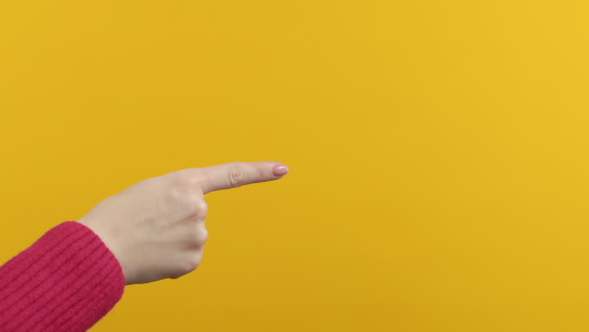 Recommending woman with hands pointing on right side copy space. Lady presenting, showing something isolated on yellow background. Empty place for your advertising.  | Shutterstock HD Video #1098237433