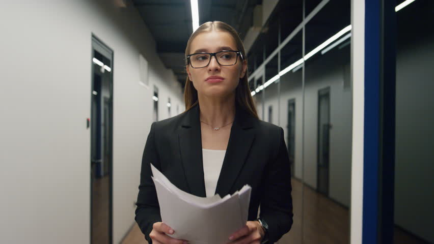 Unhappy businesswoman throwing documents in office corridor. Upset girl walking hallway relieving stress after unsuccessful client ceo meeting. Sales manager get fired. Angry woman leaving workplace | Shutterstock HD Video #1098239167