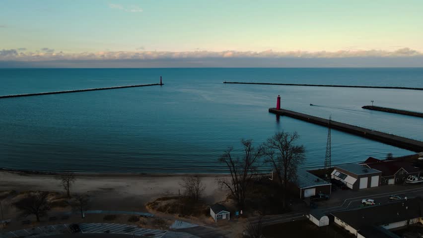 A small boat departing the Muskegon Channel in the great lake, Lake Michigan.