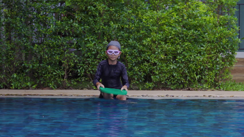 4K, Asian girl wearing black swimsuit and swimming cap, with swimming goggles, playing in children