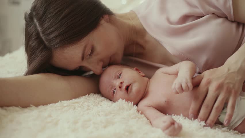 Happy mom lying with her newborn baby. | Shutterstock HD Video #1098246387