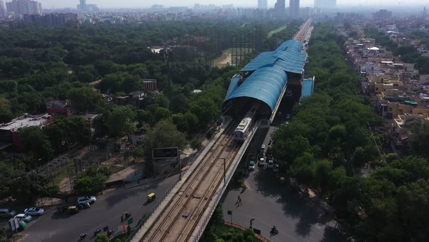 An aerial shot of the Delhi Metro leaving the station in New Delhi, India
