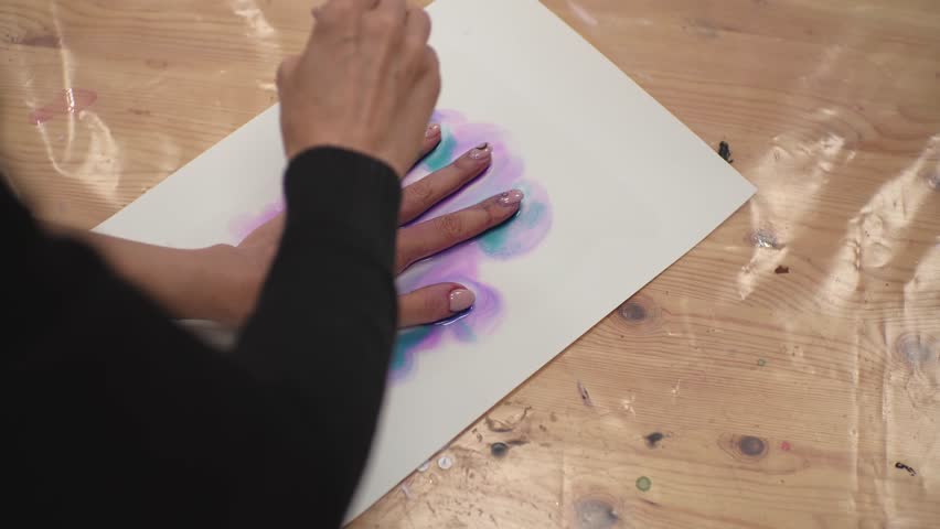 The girl circles her fingers with a brush for drawing, inflates the result with a hairdryer. High-quality shooting in 4k format | Shutterstock HD Video #1098247359