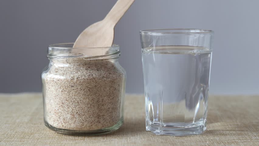 Supplement of psyllium husk and soluble fiber for the intestines. Mixing psyllium with water. Royalty-Free Stock Footage #1098247691