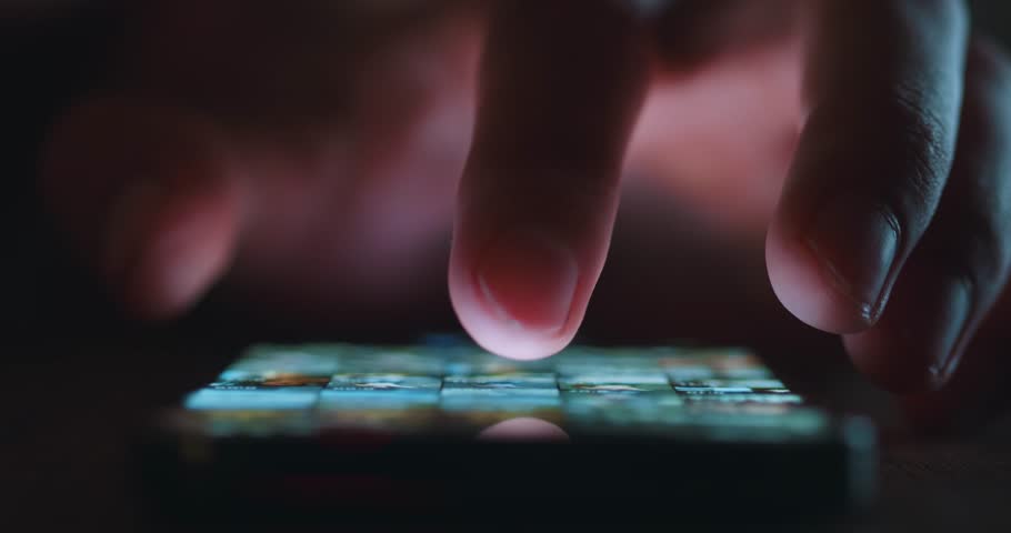 Close up of man's hand scrolling social media on smartphone at night time. Man Browse Social Network. Touch with Finger the display of modern smartphone. | Shutterstock HD Video #1098252915