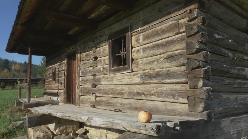Detail of old wooden rustic house front wall, windows, door and porch