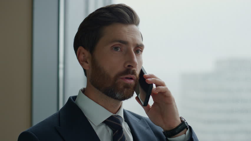 Financial consultant talking phone standing at office panoramic window close up. Business manager consulting client using modern smartphone. Confident bearded businessman have telephone conversation. | Shutterstock HD Video #1098253729