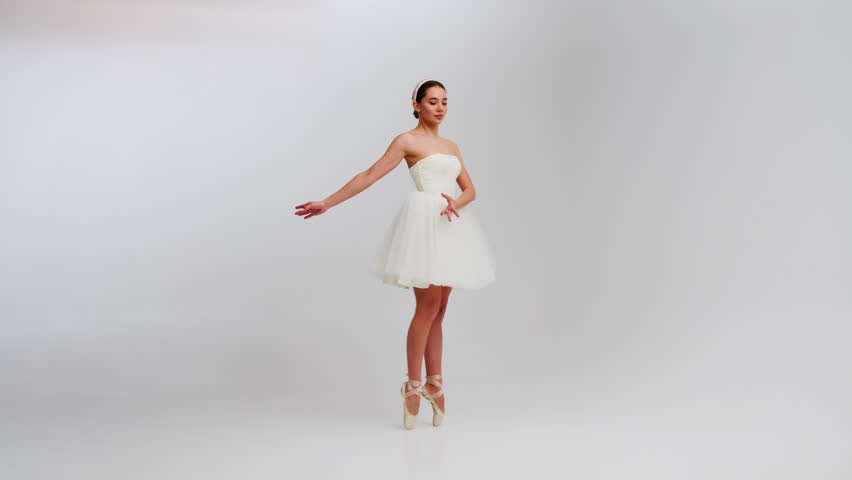 Young flexible ballerina dancing and performing acrobatic elements with a chair. Modern dramatic ballet. Slow motion. Close up.
