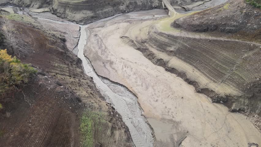 dried dam, aerial dried dam and small stream, drought