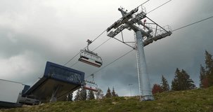 Chair lift in Bukovel - largest ski resort in Carpathian Mountains, Ukraine. Cinema 4K 60fps zoom-in video