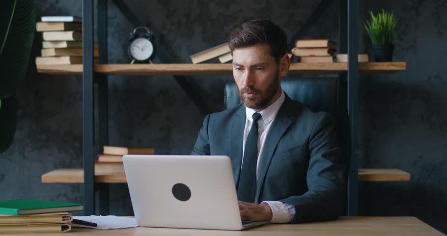 Shocked man entrepreneur upset with bad deal, looking at laptop screen, reaction on crisis. Unpleasantly surprised business man by bad email seen on computer while working at office. Problems at work | Shutterstock HD Video #1098257049
