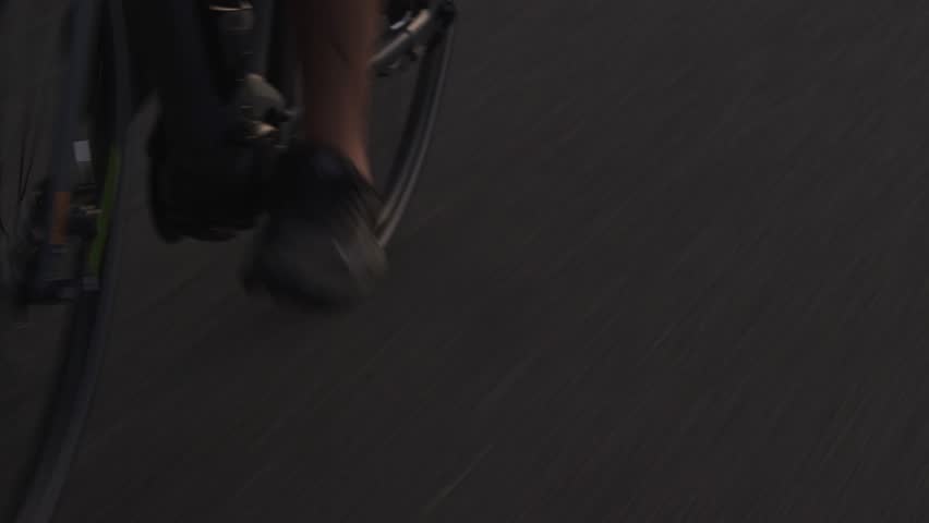 Close up of males feet and legs peddling on road bike on pavement in city | Shutterstock HD Video #1098263455