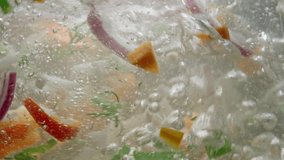 Slow motion background video of vegetables being cooked in hot water in the kitchen. The process of preparing organic healthy soup. High quality 4k footage - Powered by Shutterstock - Get 15% off with code: PIKWIZARD15
