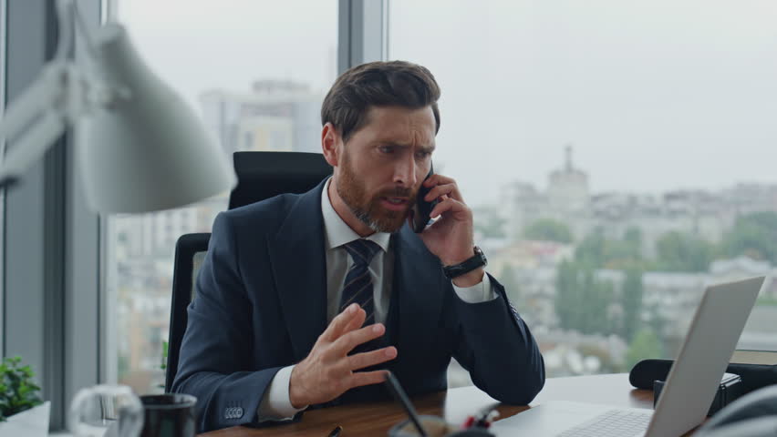 Irritated manager disputing on phone conversation with partner working modern company office close up. Annoyed elegant bearded business man owner talking smartphone nervously taking notes in notebook. | Shutterstock HD Video #1098268037