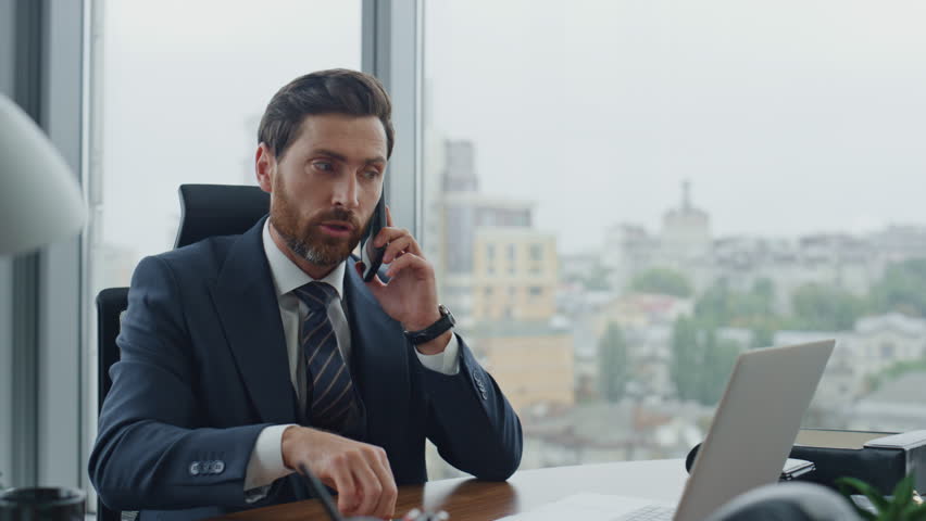 Elegant worried banker calling client borrower having nervous phone conversation close up. Annoyed businessman talking telephone emotionally dissatisfied company work. Bearded manager speaking mobile. | Shutterstock HD Video #1098268211
