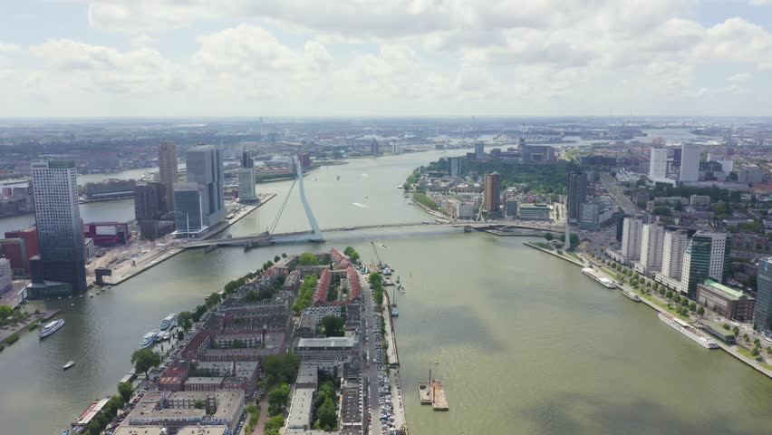 Inscription on video. Rotterdam, Netherlands. Norderayland Island ( North Island ) and Erasmus Bridge ( Erasmusbrug ) over the Nieuwe Maas River. Text furry, Aerial View, Point of interest