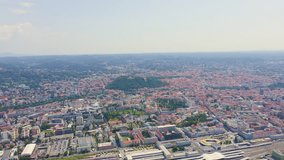 Inscription on video. Graz, Austria. The historic city center aerial view. Mount Schlossberg (Castle Hill). Multicolored text appears and disappears, Aerial View, Point of interest