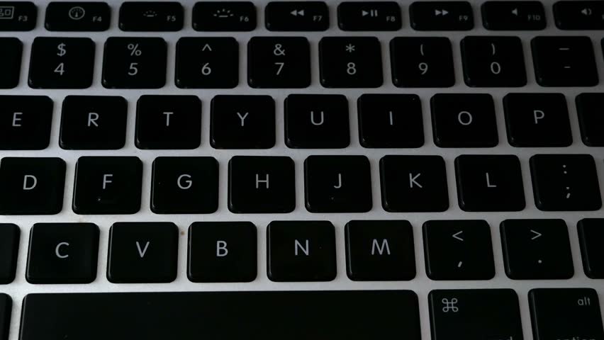 laptop keyboard and hand puts papaer arrow with agile title, software scrum agile board with paper task, concept, closeup	