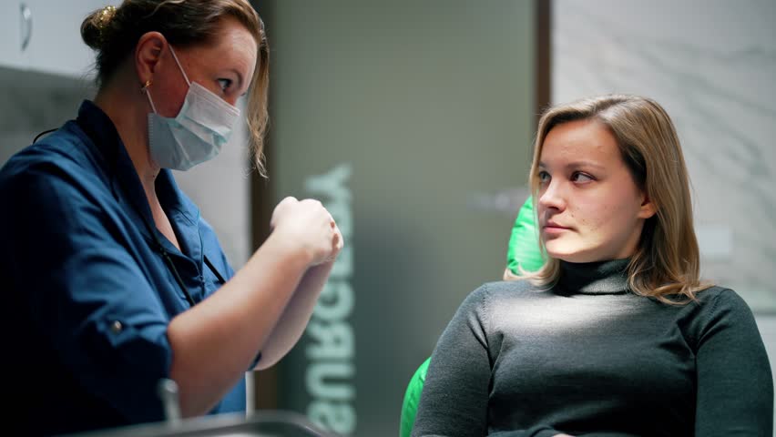 Woman lies in chair with mouth open at dentist appointment. Doctor do preventive examination using medical instruments to detect caries, problems or dental disease. Treatment in office dental clinic. Royalty-Free Stock Footage #1098273655
